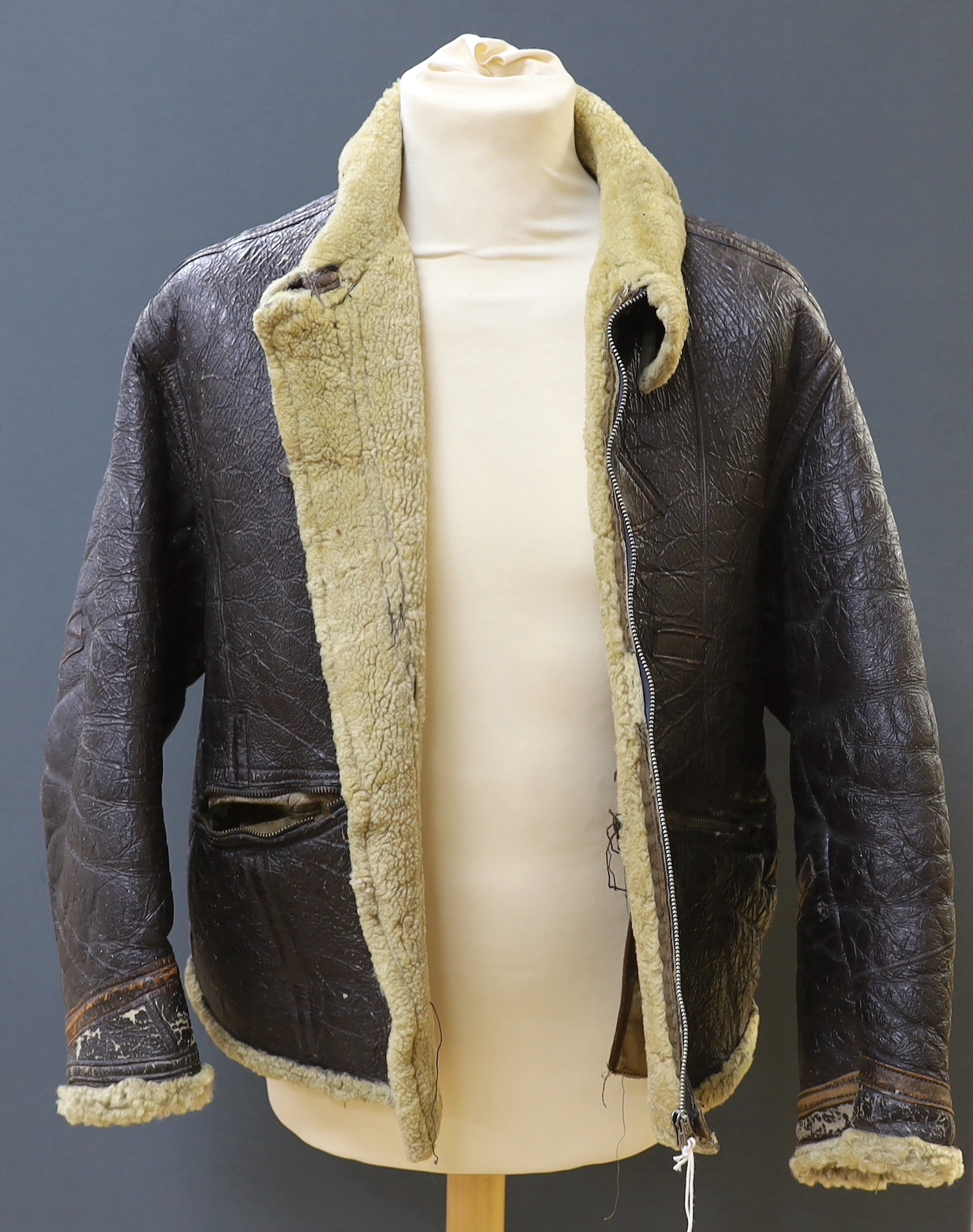 An American US Air Force sheepskin flying jacket, with applied label in collar reading ‘TYPE ….. SIZE MEDIUM SPEC NO. 94-3084 ORDER NO 42-12685-P PROPERTY AIR FORCE U.S. ARMY H. BERNSTEIN & CO.’